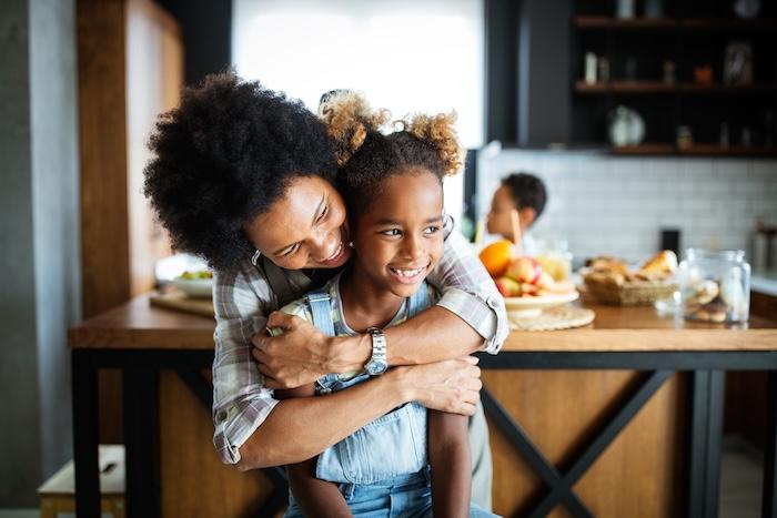 A happy mother and daughter smiling together