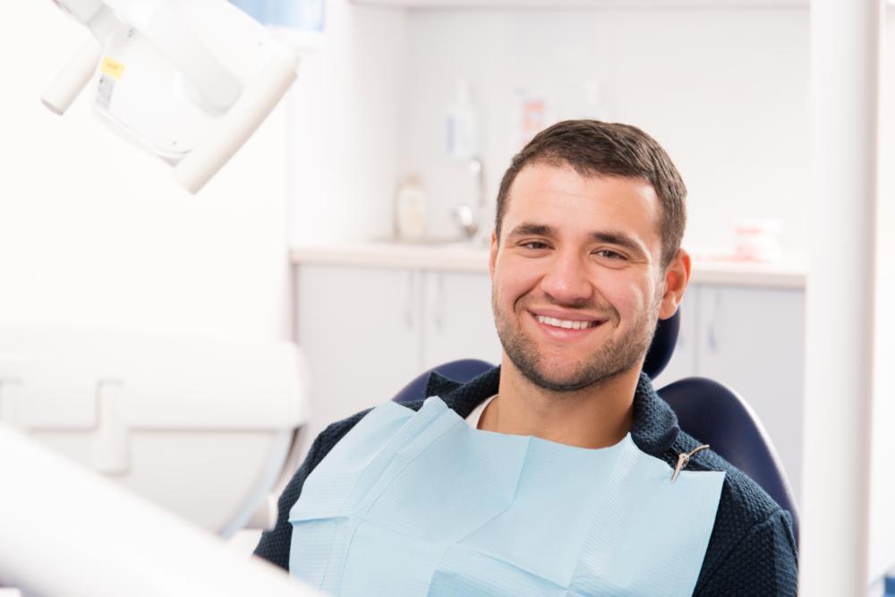 Patient smiling in treatment chair for dental exam & cleaning in Winston-Salem