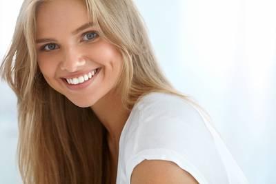 Woman smiling after emergency dental care in Winston Salem NC