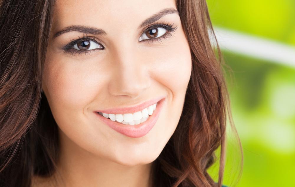 Dental patient smiling after tooth extraction procedure in 27103