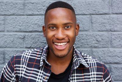 Smiling dental patient wearing dental crowns in Winston Salem NC