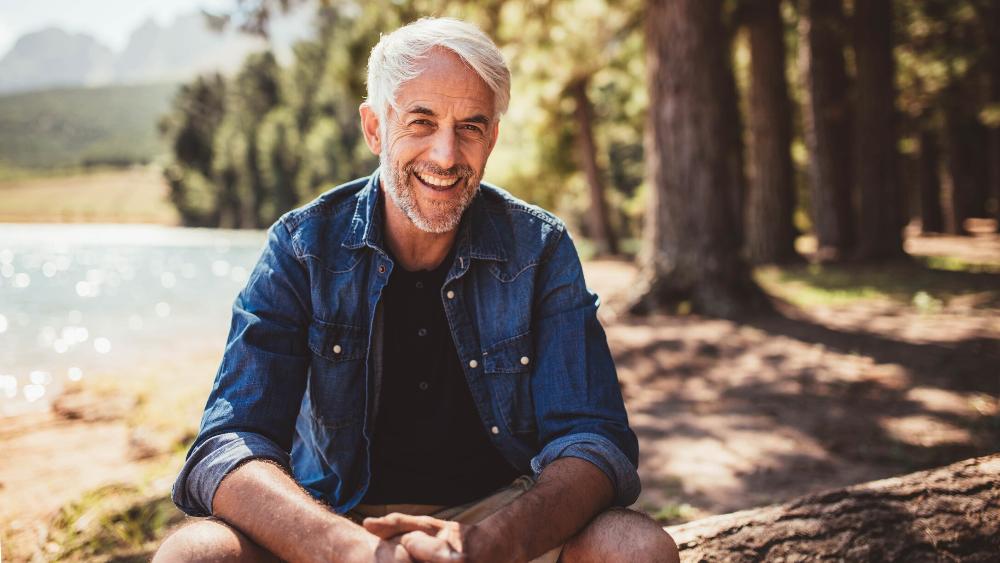 man smiling after getting dentures in winston-salem