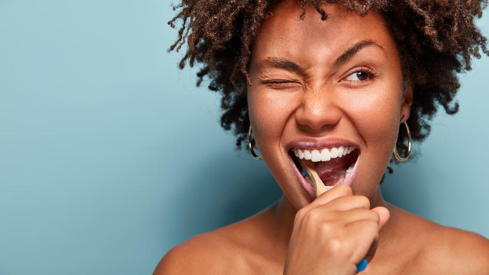 woman brushing her teeth 