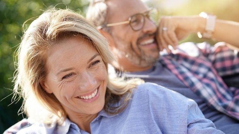 Older couple smiling outside