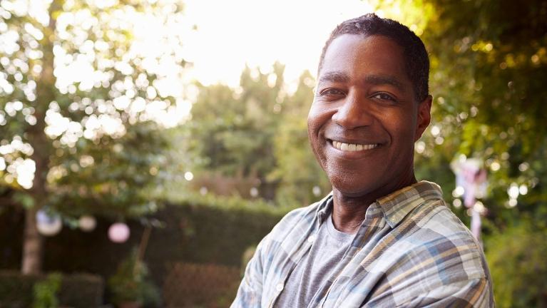 man smiling outside in a park near Winston-Salem