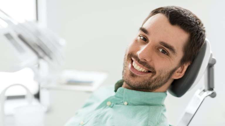 Smiling man in a dental chair