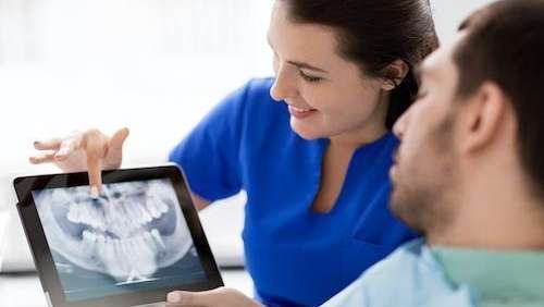 dentist showing patient their digital dental x-ray