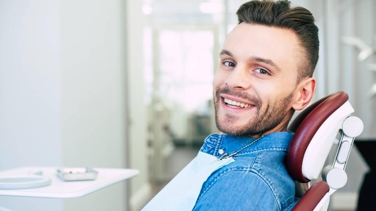 man sitting in dental chair